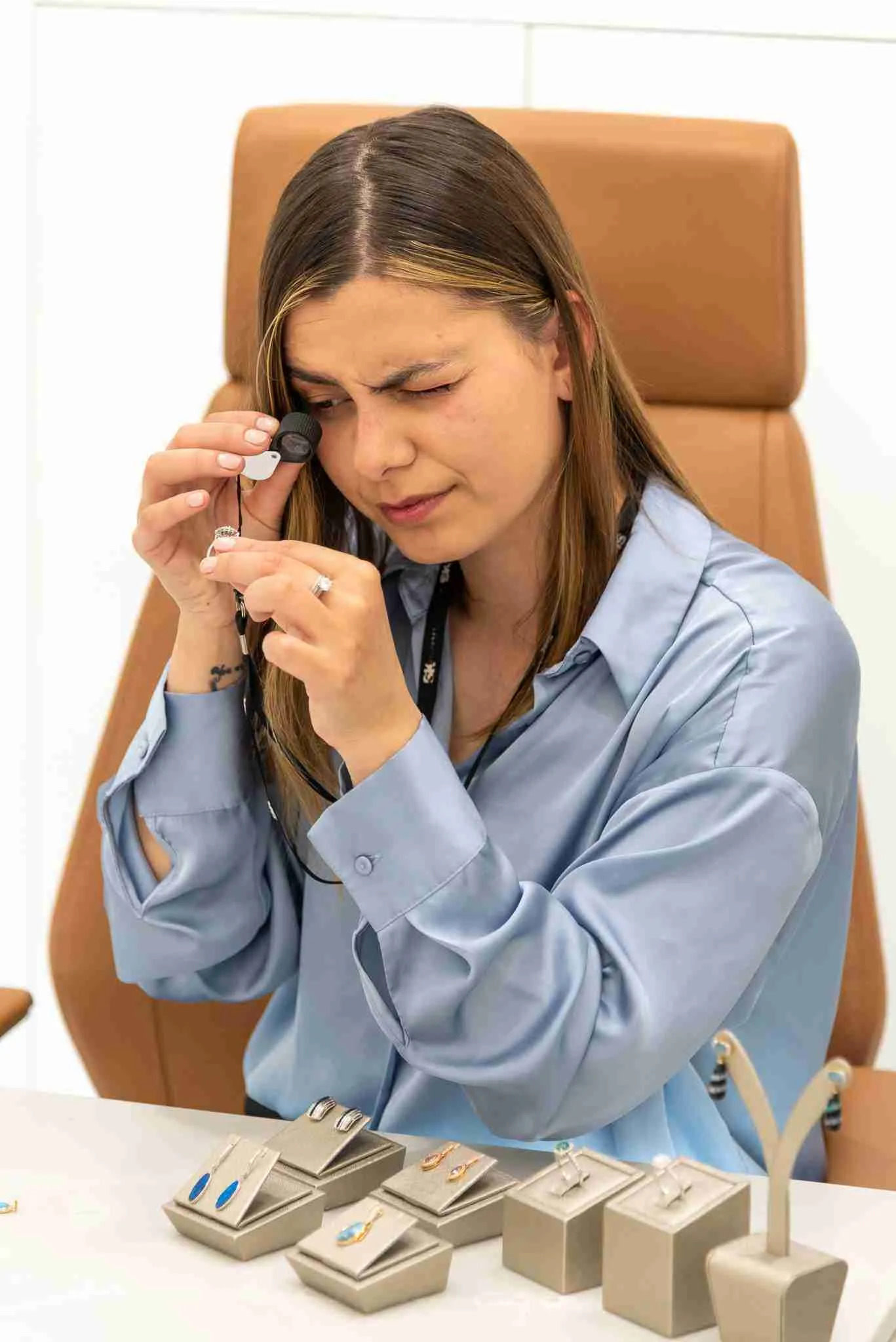 A lady doing a jewellery valuation