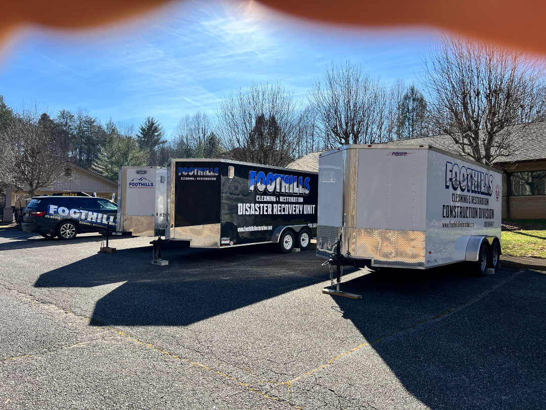 Foothills Construction and Restoration Services trailers and vehicles staged for disaster recovery operations in Black Mountain, NC. Call (828) 537-4457.