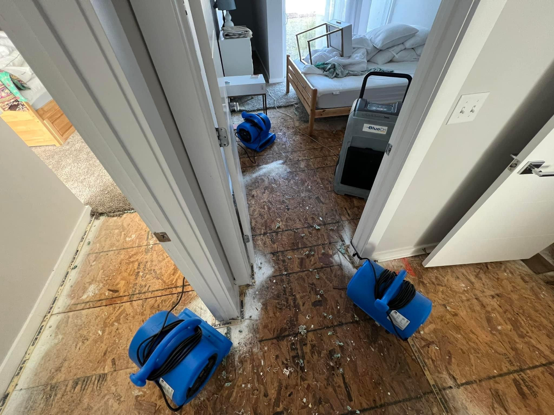 Residential interior with dehumidifiers and air movers used during water damage mitigation by Foothills Construction and Restoration Services in Black Mountain, NC. Phone (828) 537-4457.