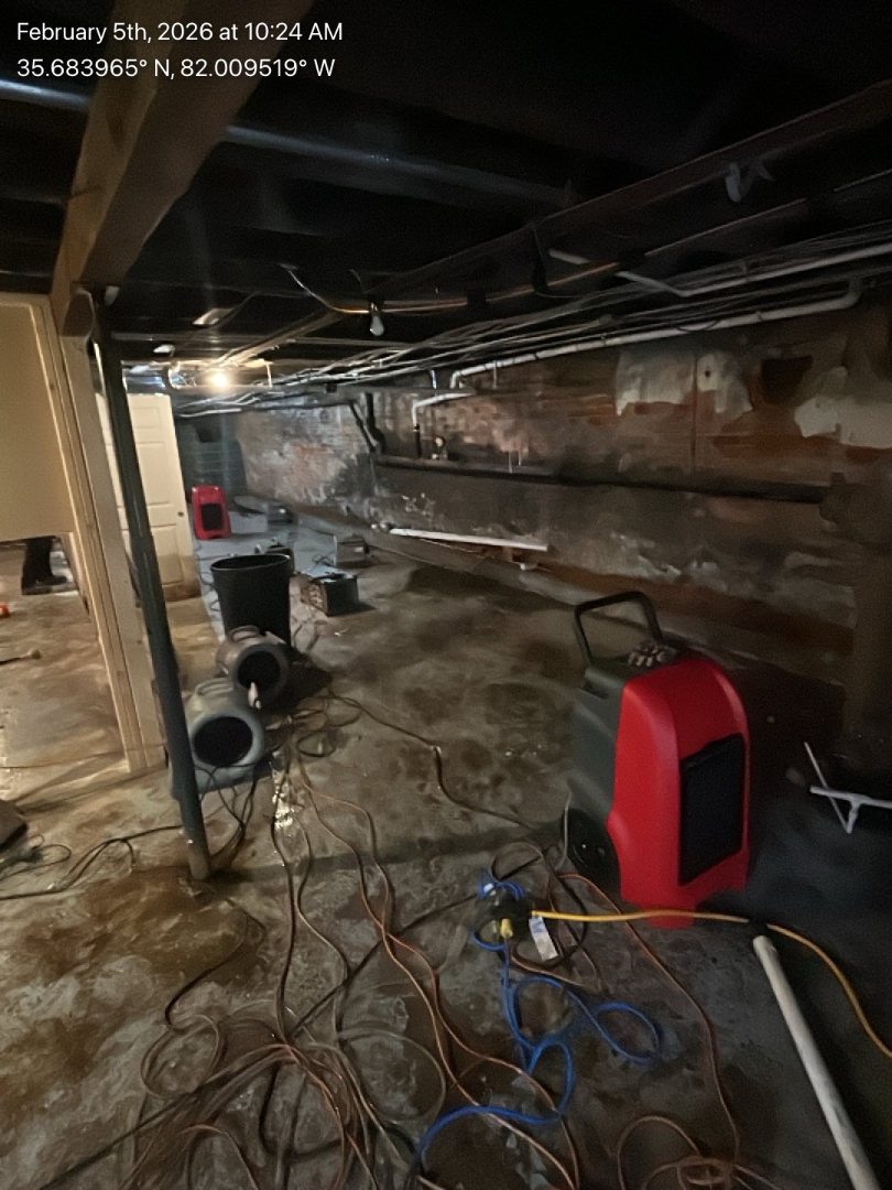 Water damage drying equipment operating in a residential crawlspace, showing dehumidifiers and air movers used by Foothills Construction and Restoration Services in Forest City, NC. Call (828) 537-4470.