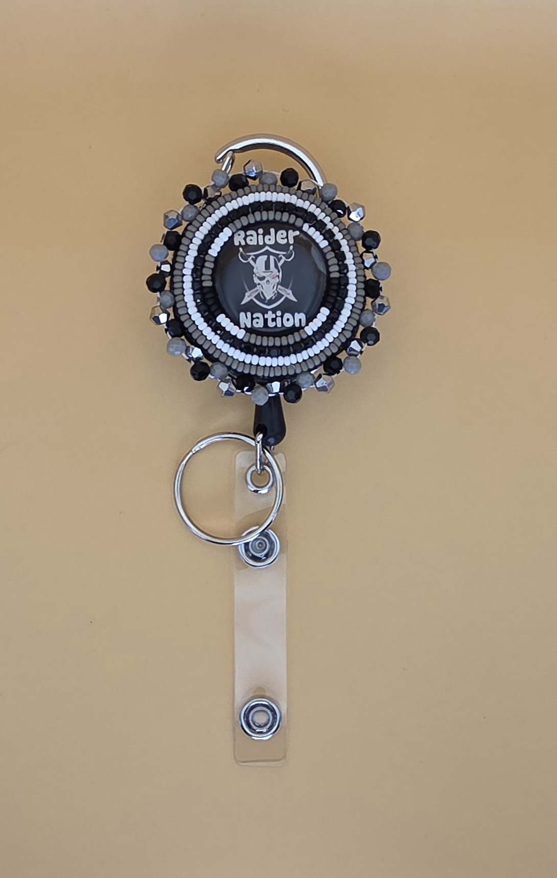 Raider Nation Beaded Badge Reel — Silver & Black Edition
