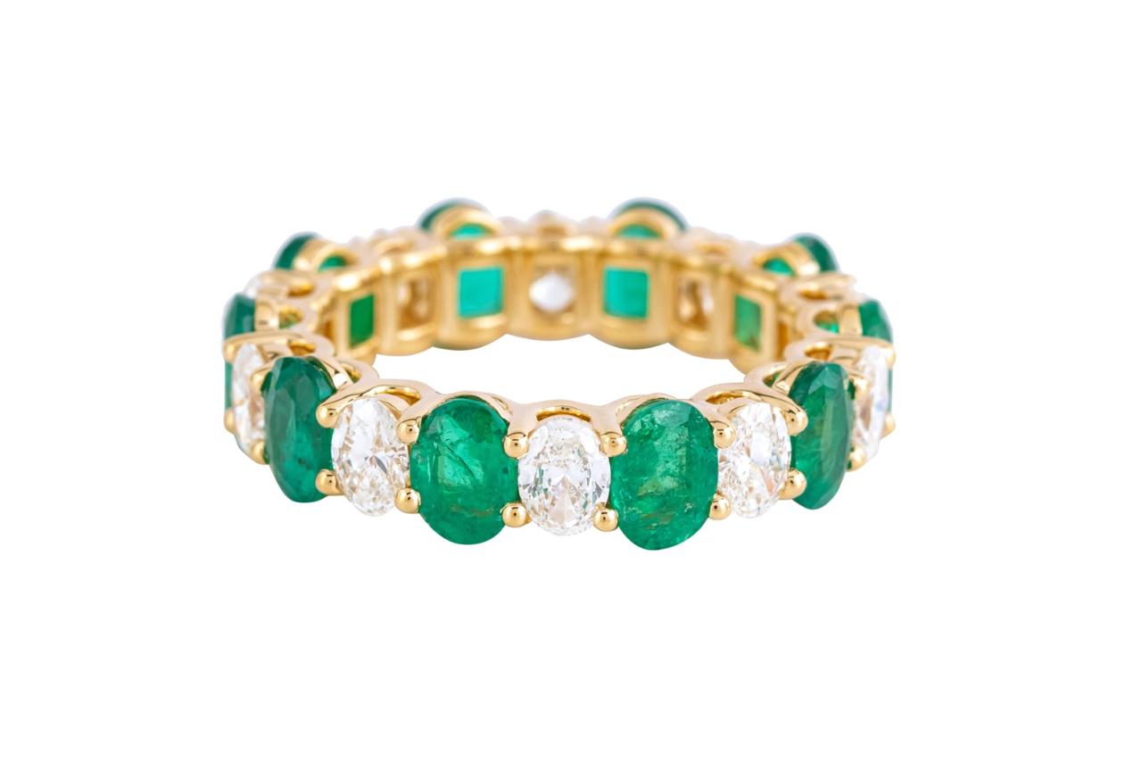 OVAL EMERALD AND DIAMOND ETERNITY BAND RING