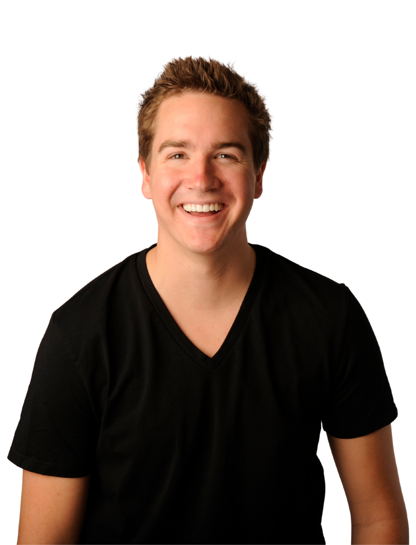 A woman in a white shirt is smiling with her hand on her chin