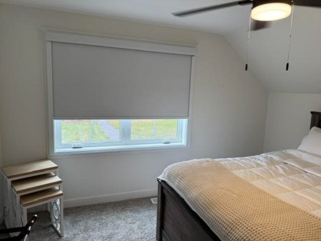 Light filtering roller shades installed in a bedroom by Simmonds Blinds and Drapes serving Alvaton, KY. Call (270) 550-1334 for custom window coverings.
