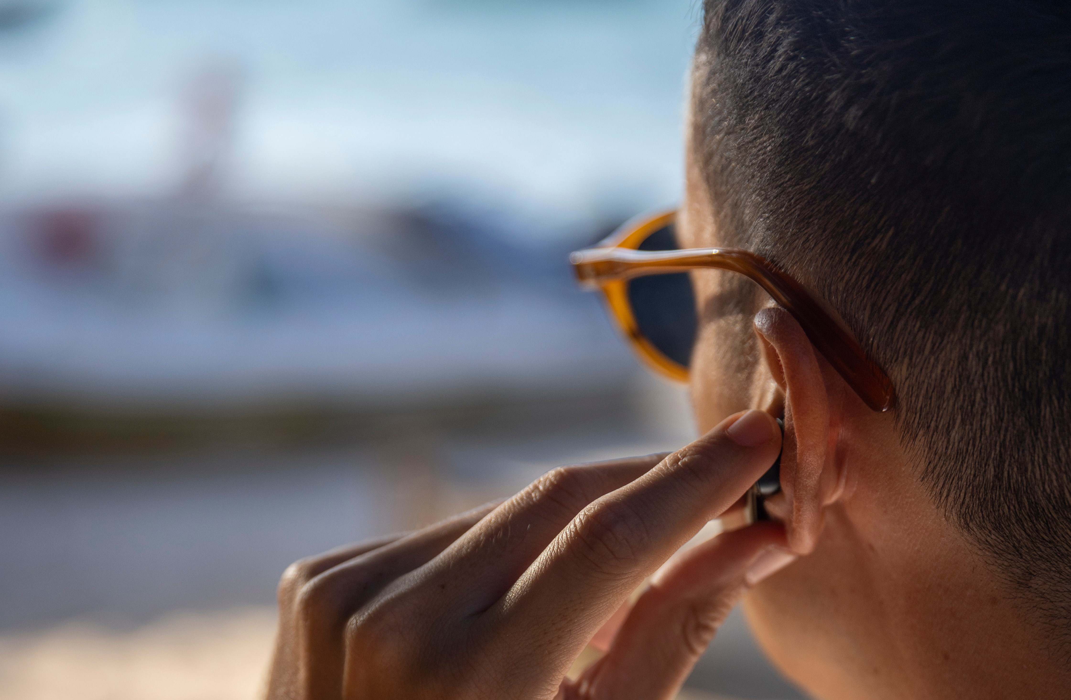 Guy putting earbuds