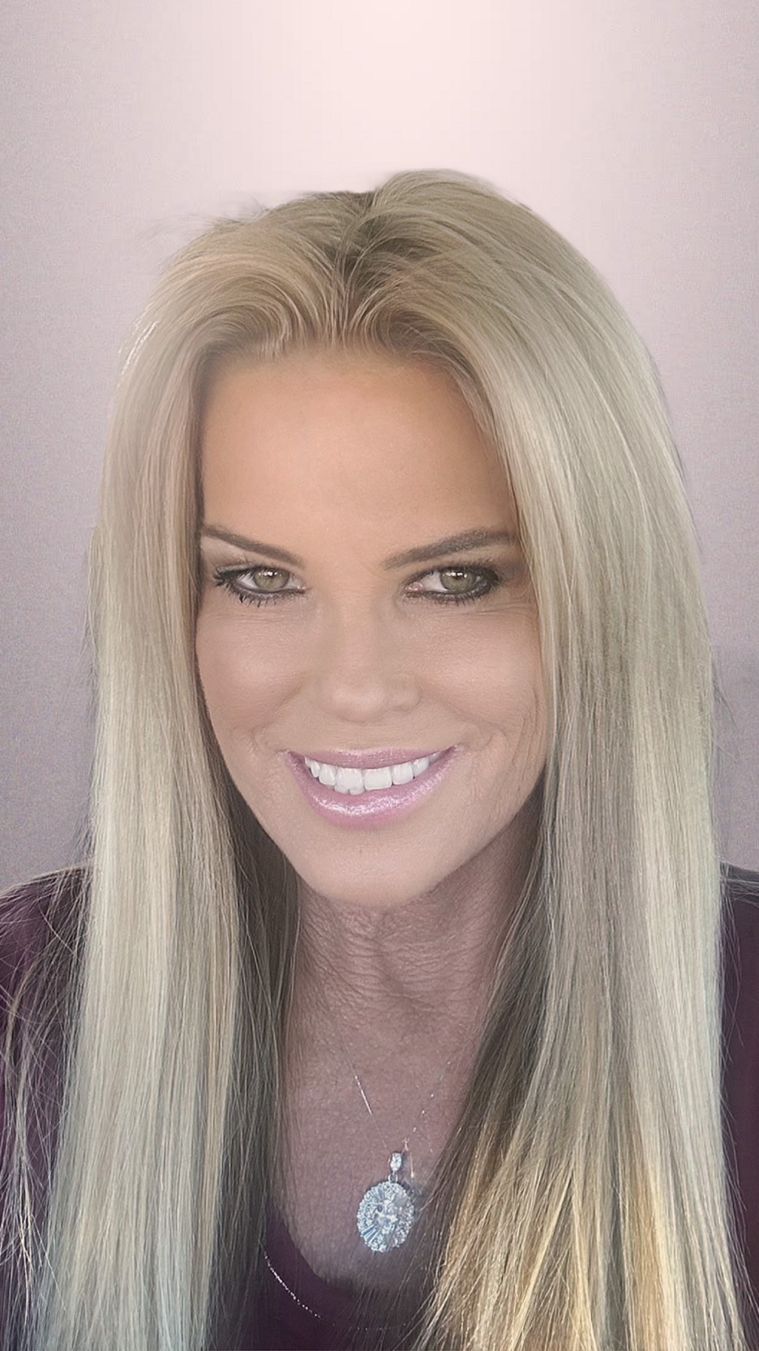 a woman wearing a black jacket and a red scarf is smiling for the camera .