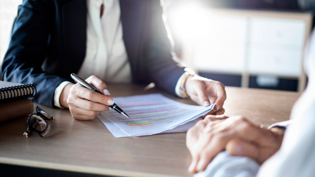 A woman doing manual underwriting
